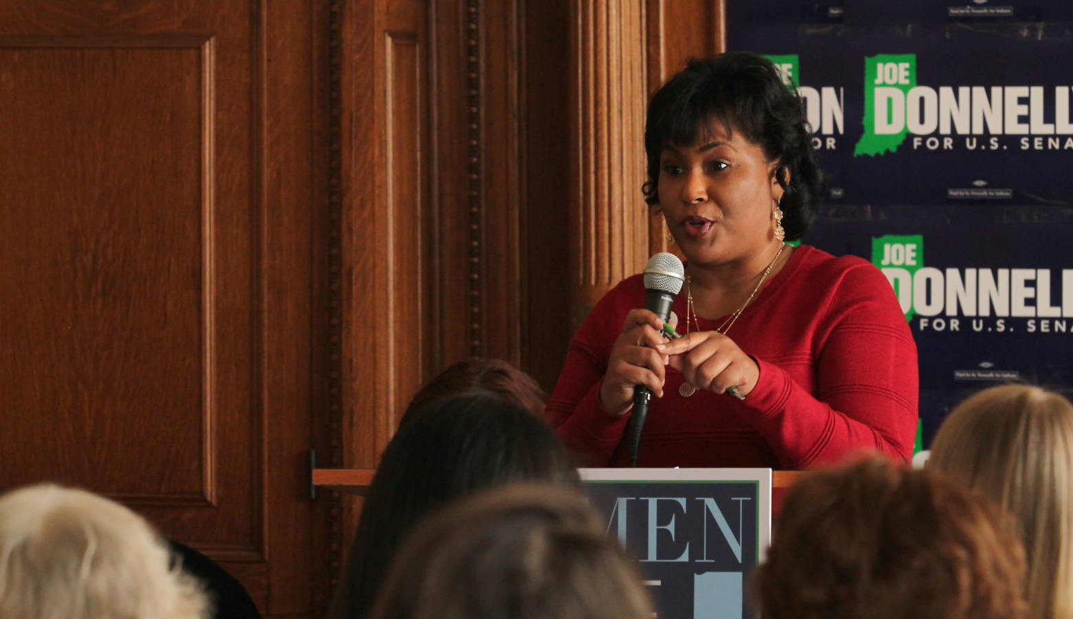 Rep. Cherrish Pryor (D-Indianapolis) shares her experiences with U.S. Sen. Joe Donnelly with a crowd in Indianapolis. (Lauren Chapman/IPB News)