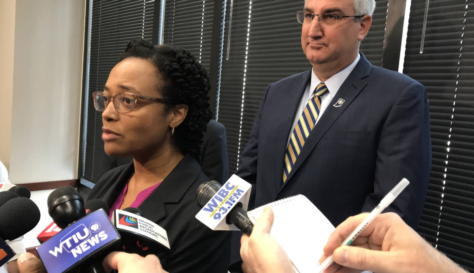 DCS Director Terry Stigdon, at left, and Gov. Eric Holcomb, right, discuss an independent evaluation of the embattled state agency. (Brandon Smith/IPB News)