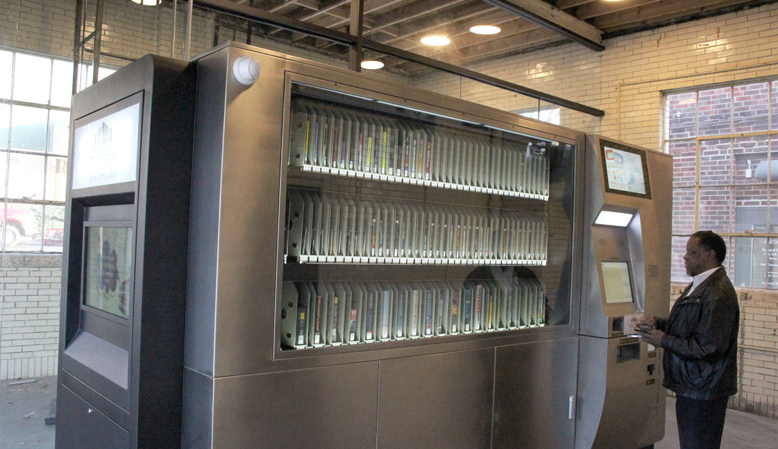 Tippecanoe County Public Library librarian Jos Hulman tests machine just before its grand opening. (Samantha Horton/IPB News)