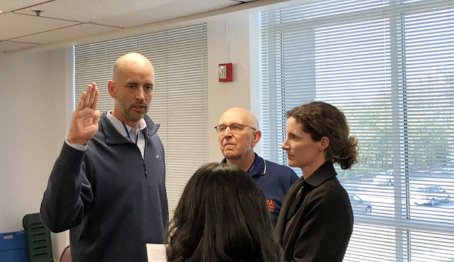 Ryan Mears takes an oath into office. He is joined by former county prosecutor Terry Curry and wife, Shannon Mears.