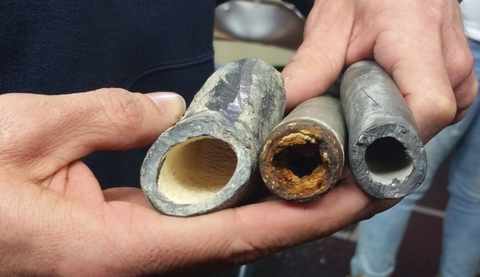 An EPA civil engineer shows how corrosion control treatments can affect lead pipes. The one on the left was treated, the middle one was not, and the one on the right is a new pipe. (FILE PHOTO: Lauren Chapman/IPB News)