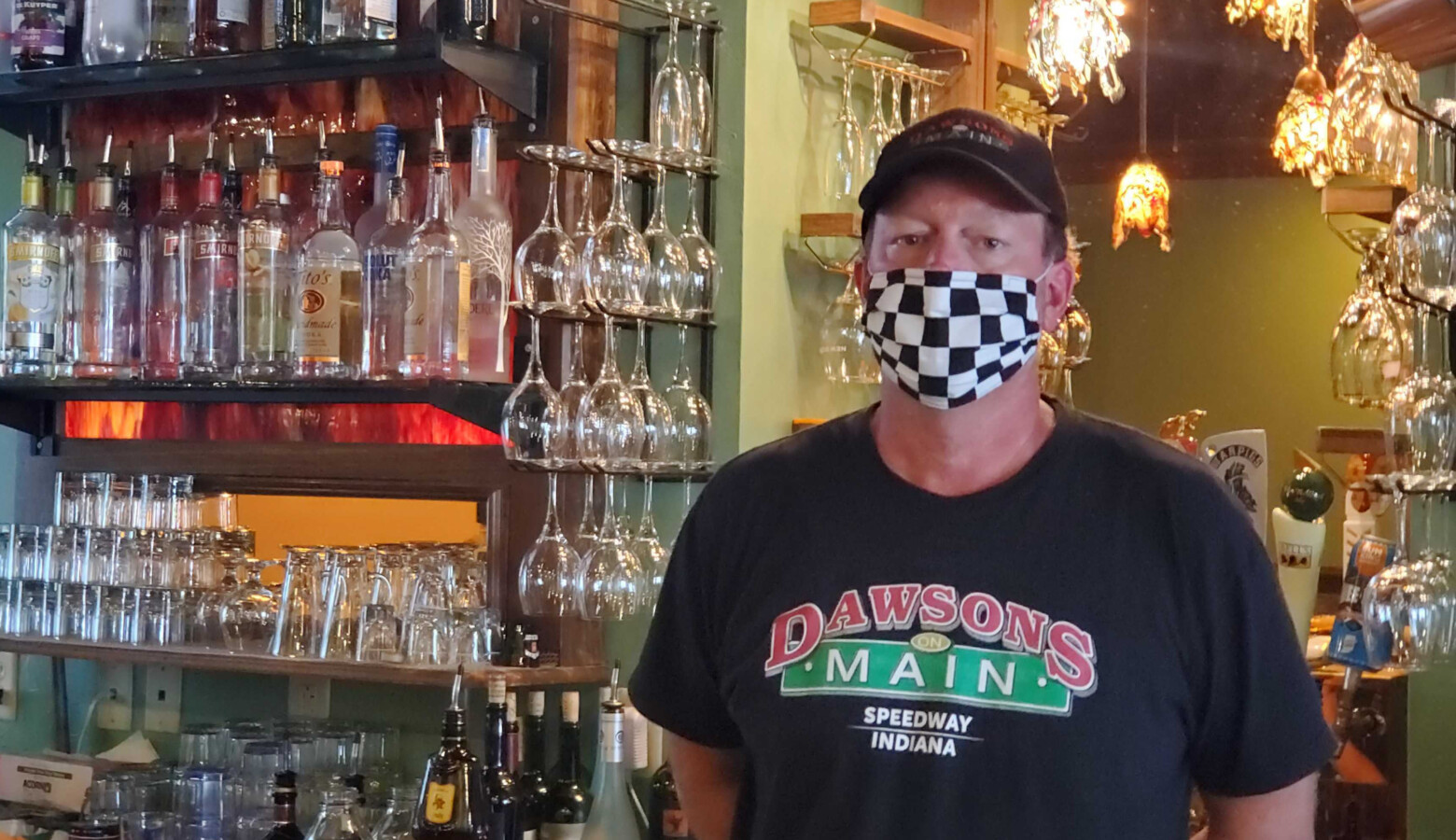 Dawson’s On Main co-owner Chris Hill stands behind the bar at his restaurant just a short walk from the Indianapolis Motor Speedway. (Samantha Horton/IPB News)