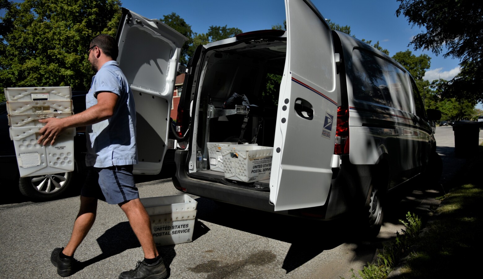 A postal worker in South Bend delivering mail. (Justin Hicks / IPB News)