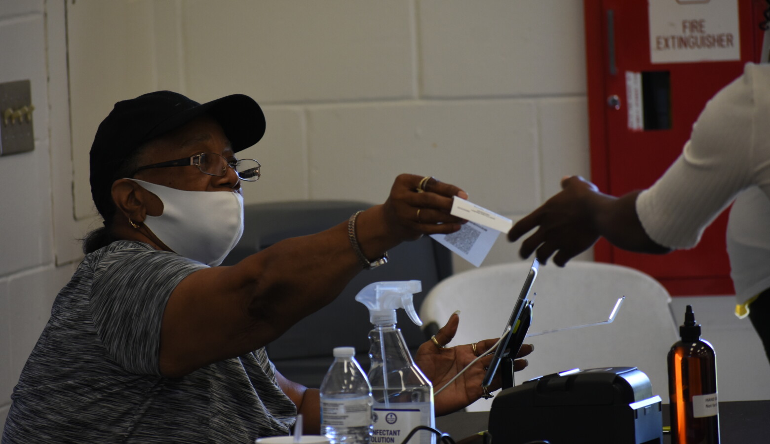 Poll workers and voters will have access to personal protective equipment at polling places this fall, like they did in the primary. The poll worker seen from June isn't wearing their mask correctly, blunting its effectiveness at halting COVID-19's spread