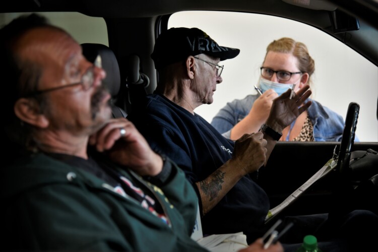 Workers get information about job openings at a drive-thru employment fair in Elkhart during the pandemic. (Justin Hicks/IPB News)