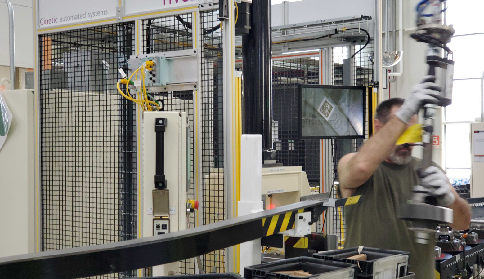 A worker assembles parts along the line at FCC Transmission plant in Tipton, Indiana. (Samantha Horton/IPB News)