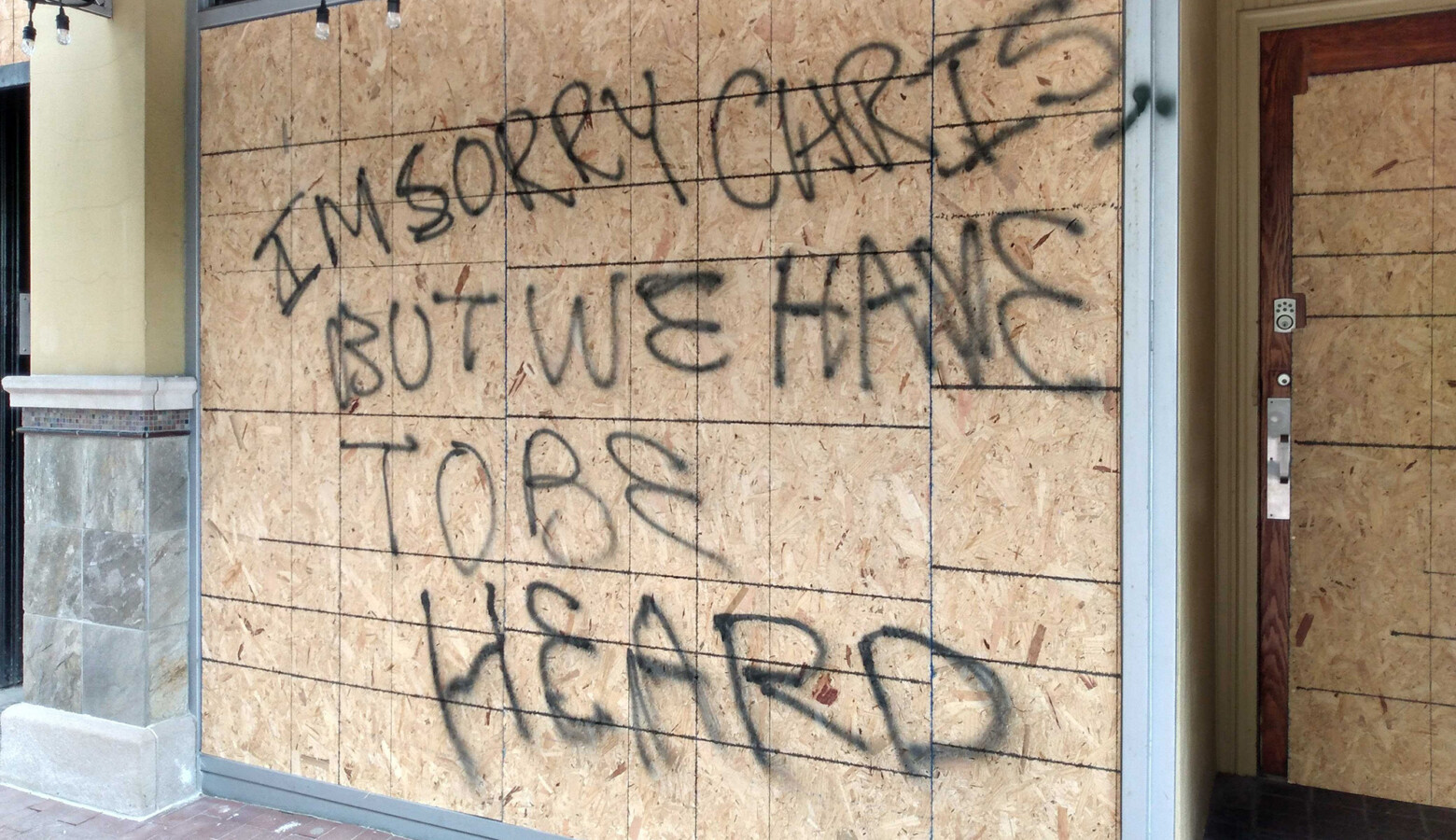 In Indianapolis, the first business with a broken window was Jack's Donuts, just east of the Statehouse. Protesters left a message for the owner after the clashes with police: "I'm sorry Chris, but we have to be heard." (Lauren Chapman/IPB News)