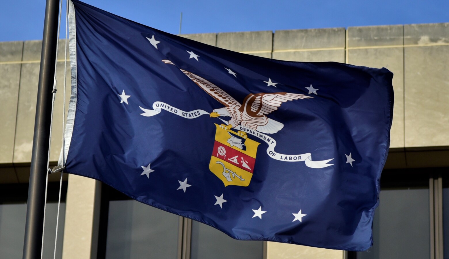 The Department of Labor seal on a flag flying outside the federal headquarters in Washington D.C. (Justin Hicks/IPB News)