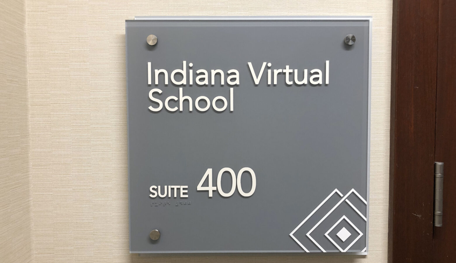 A sign on a wall reads Indiana Virtual School, Suite 400.