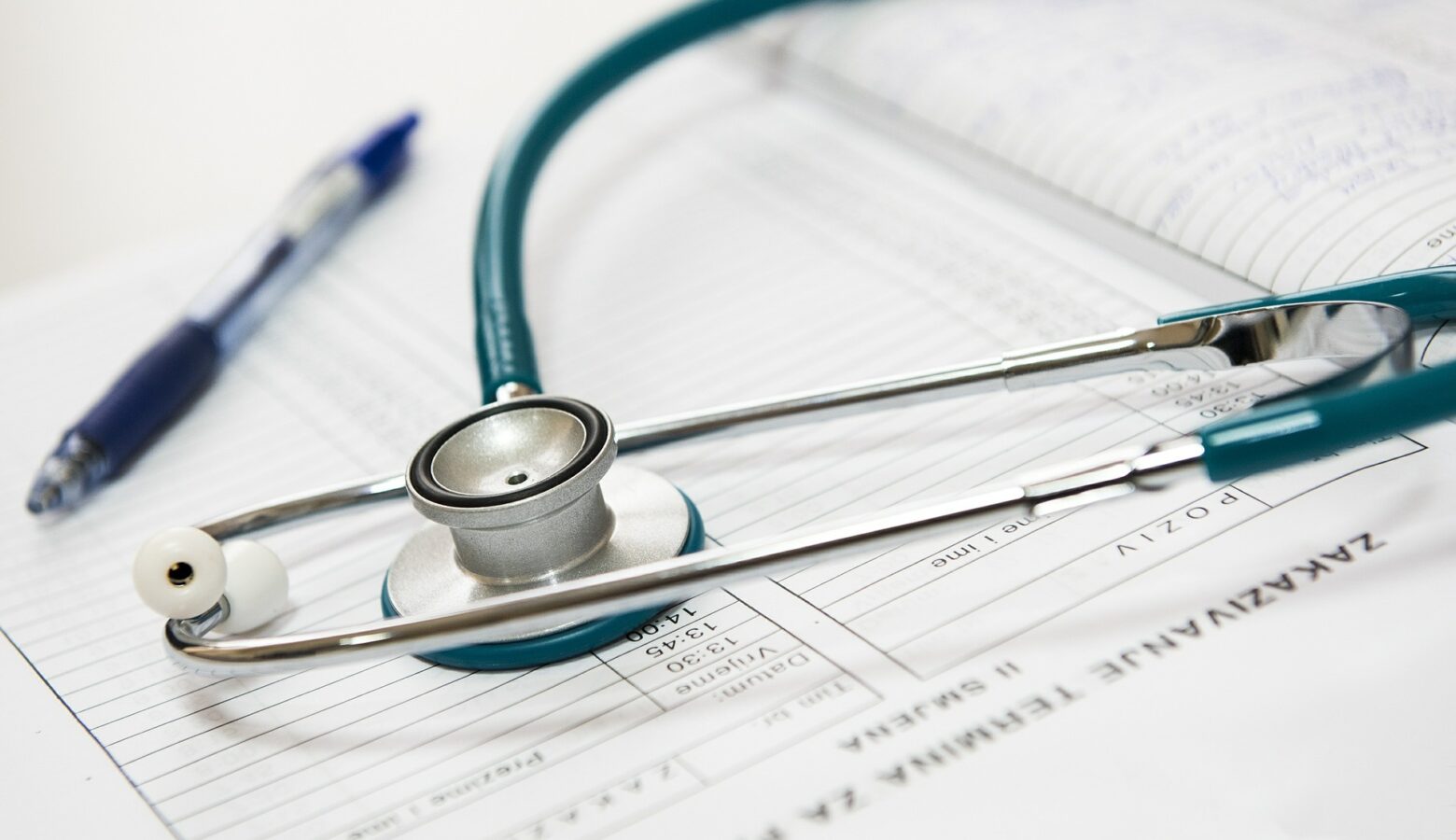 A blue stethoscope sits on a medical chart.