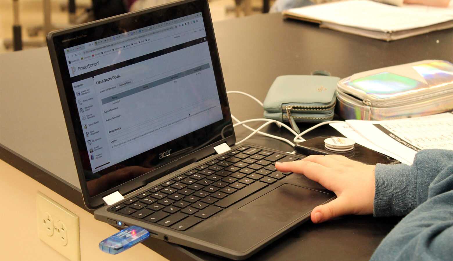 A student uses a laptop at a table.