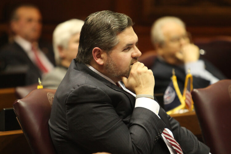 Representative Ed Clere sits at his desk in the Indiana House of Representatives.