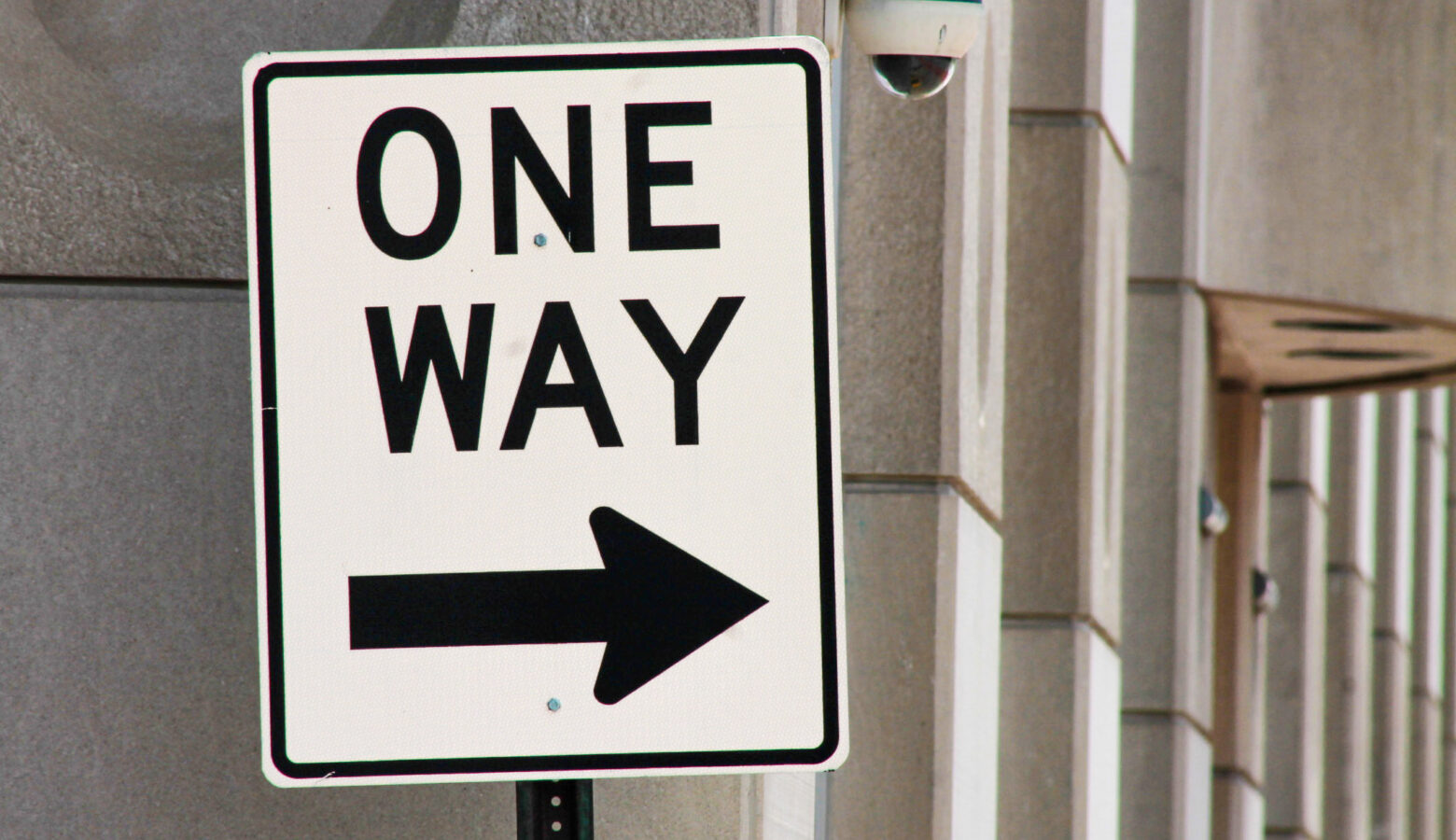 A road sign reads "One Way" with an arrow pointing to the right.