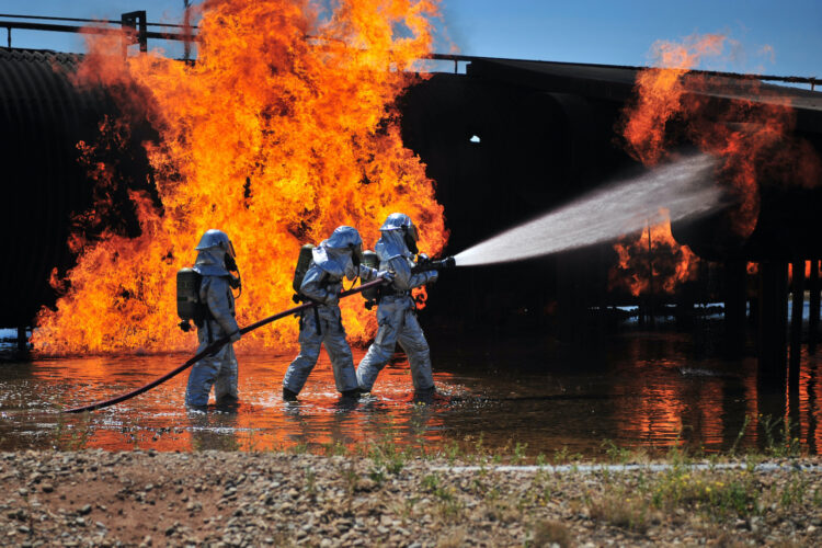 U.S. Air Force firefighters work to extinguish a simulated engine fire at Cannon Air Force Base in New Mexico in 2012.