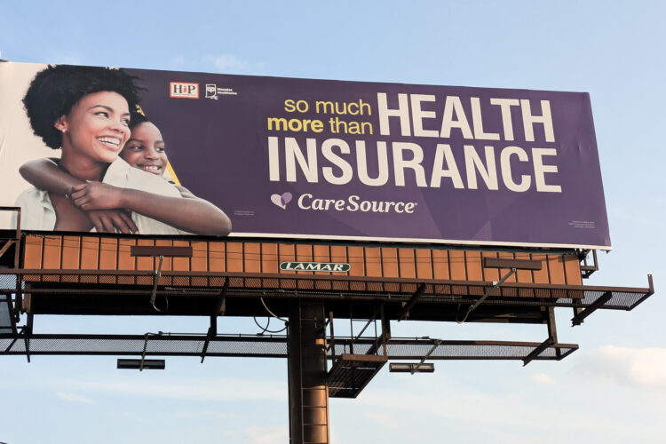 A billboard for the Health Indiana Plan reads 'so much more than health insurance.'