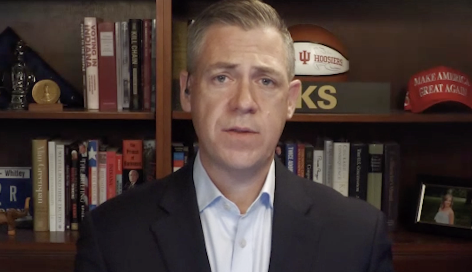 A screenshot of a Zoom call with Jim Banks. Banks is a White man with graying hair. He is wearing a dark suit jacket and light-colored shirt.