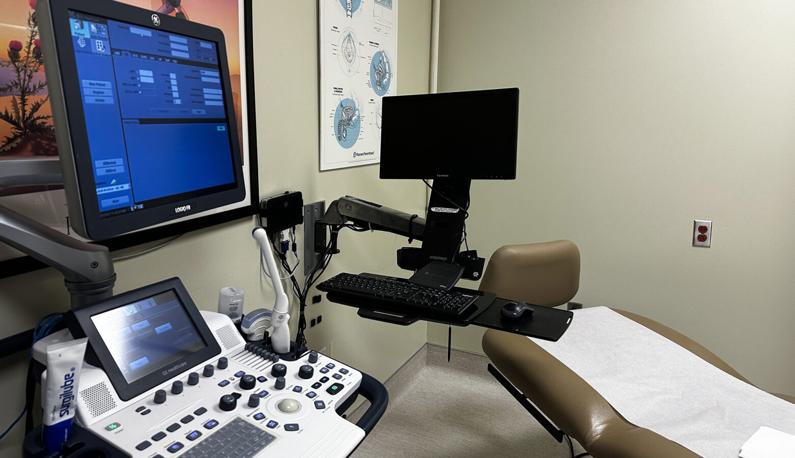 A patient exam room with an exam table and a computer for inputting patient information.