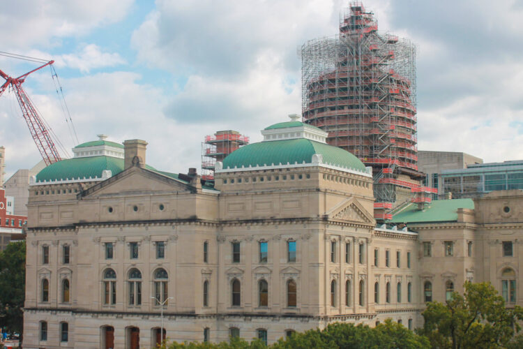 The northern exterior of the Indiana Statehouse. Its dome is surrounded by scaffolding.