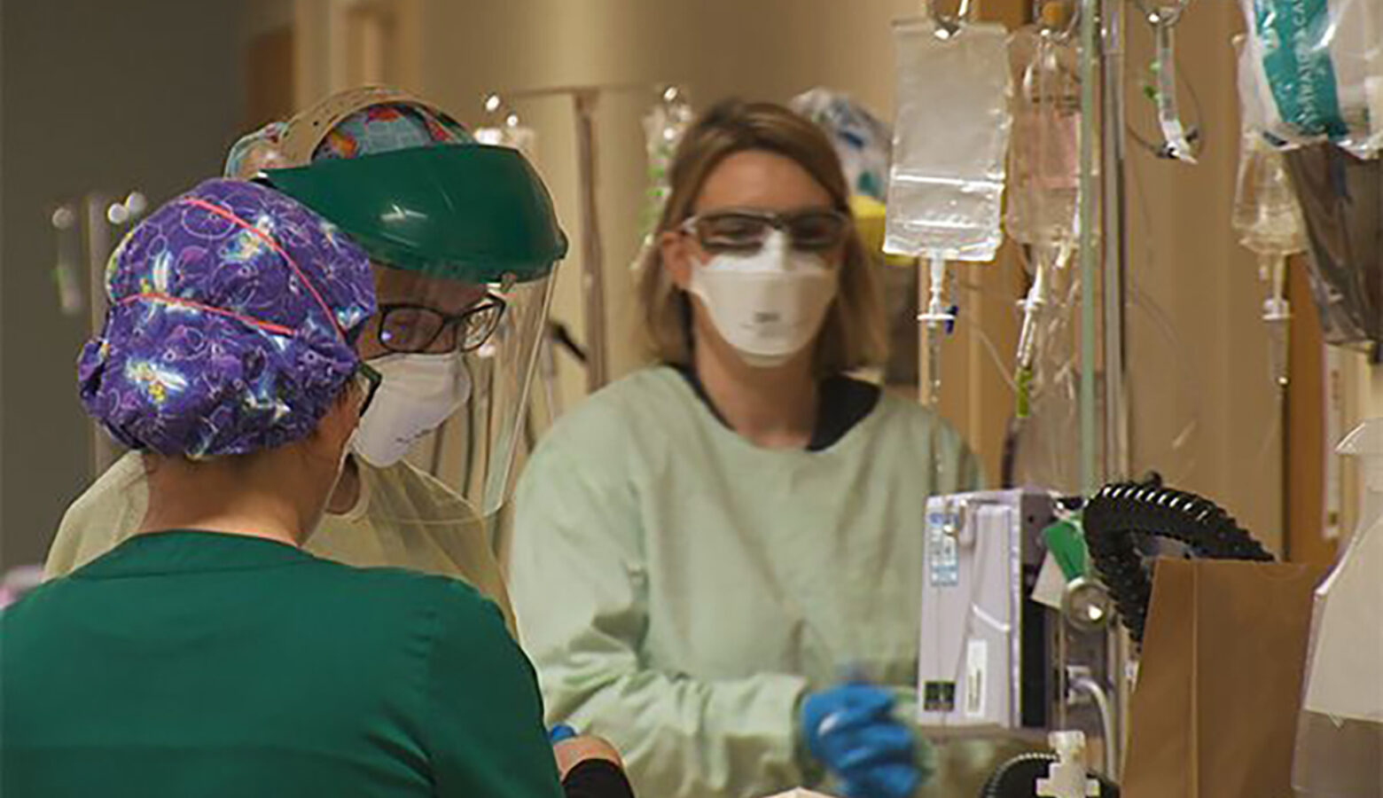 A medical team transports a patient down a hallway in a hospital.