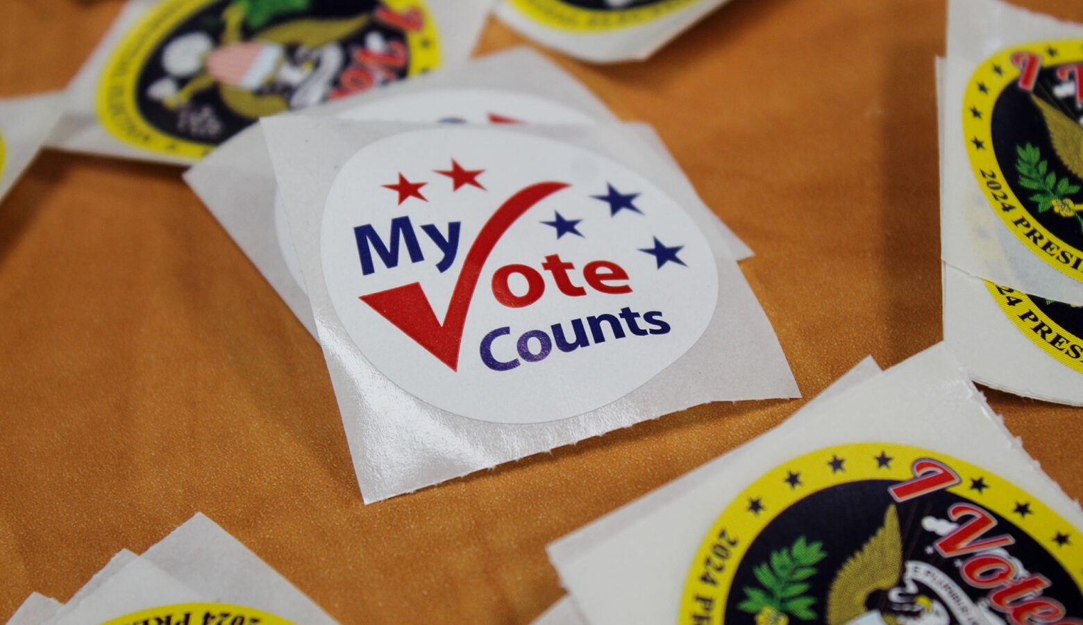 A sticker reads "My Vote Counts" with a checkmark forming the V.