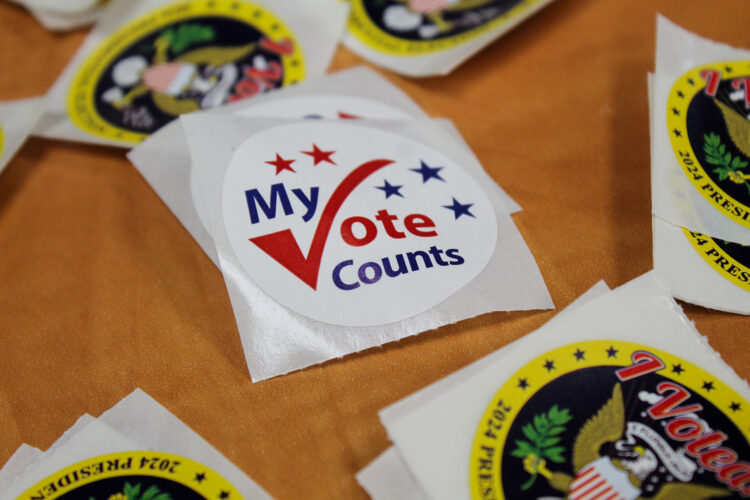 A sticker reads "My Vote Counts" with a checkmark forming the V.