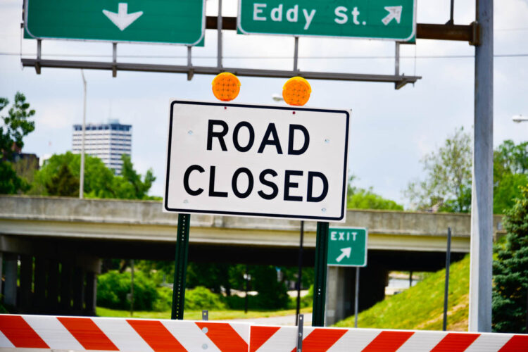 A road sign reads "Road Closed."