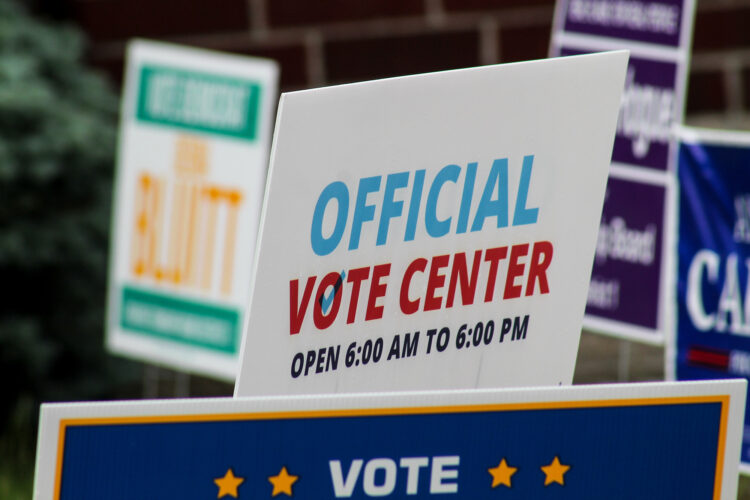 A lawn sign reads "Official Vote Center."