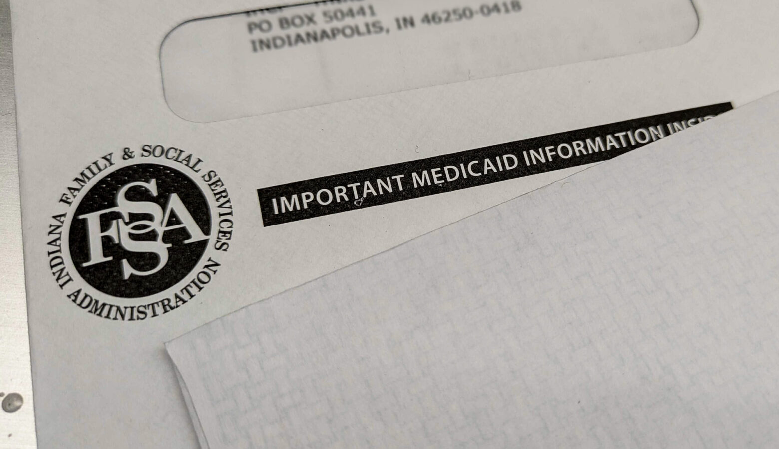 An envelope with a black Indiana Family and Social Services Administration logo on it reads, "Important Medicaid Information Inside."