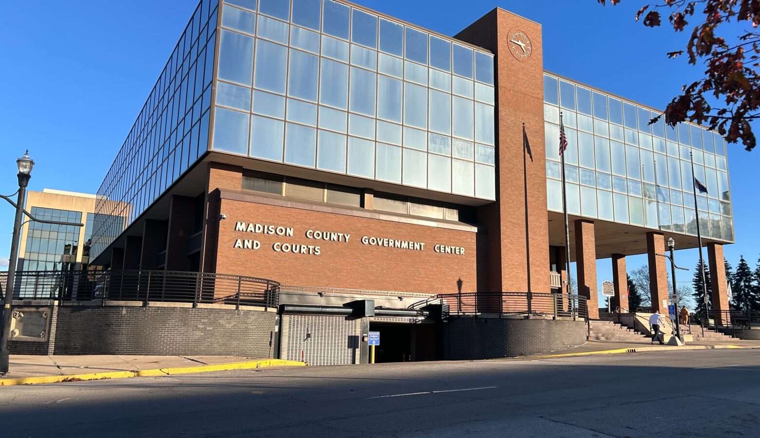 A brick building with large windows on its second floor. The words Madison County Government Center are spelled out on the wall.