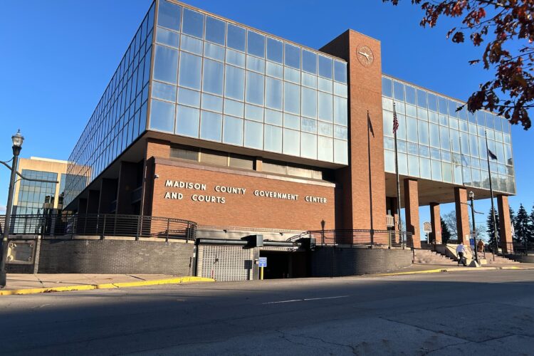 A brick building with large windows on its second floor. The words Madison County Government Center are spelled out on the wall.