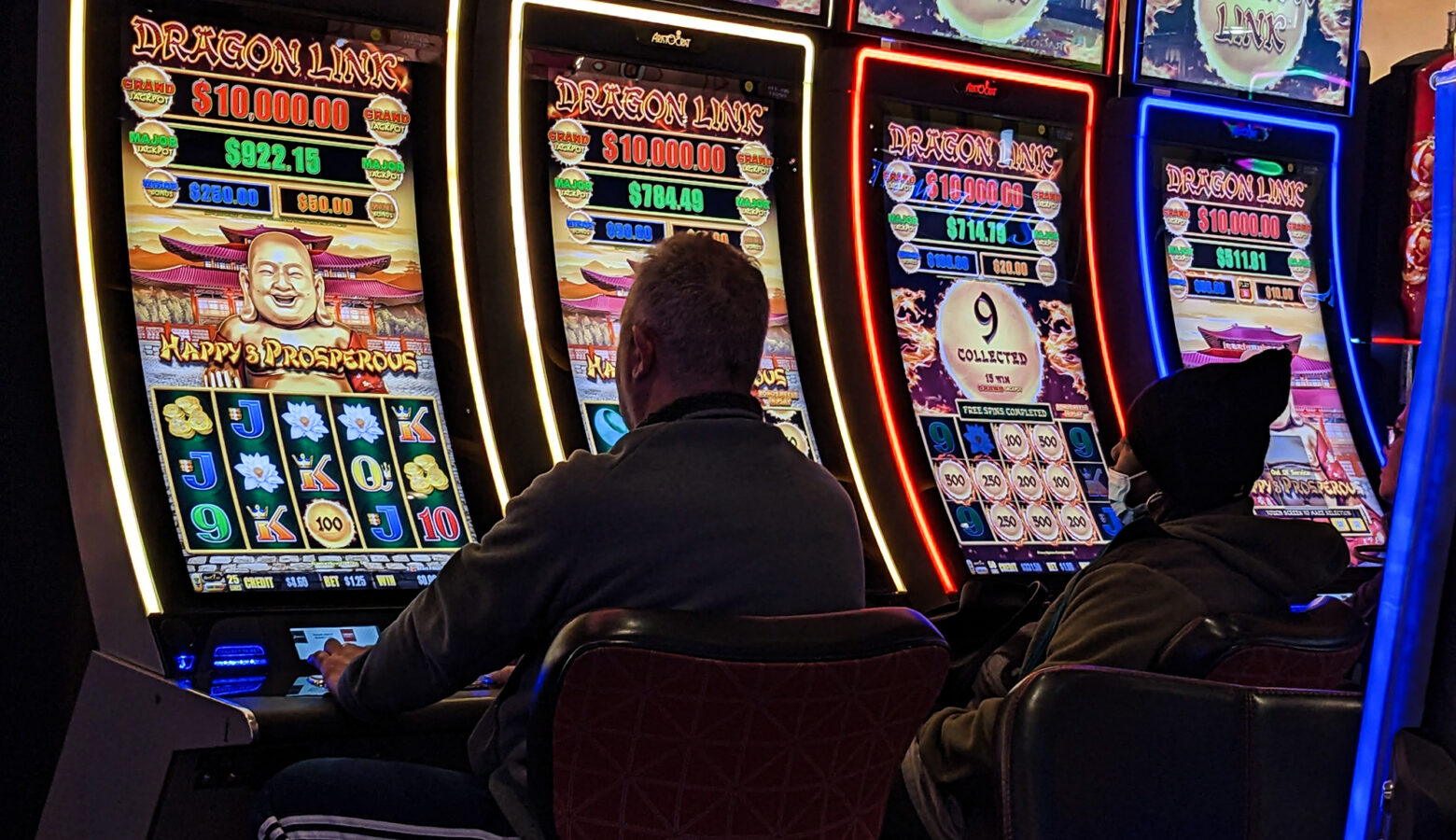 A person sits at a slot machine.