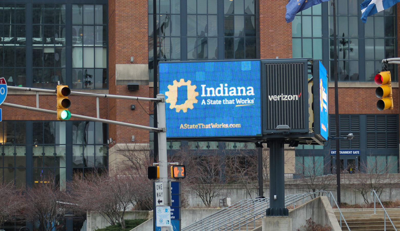 There is a sign on a blue screen that says "Indiana" in white letters across the top and the phrase "A state that works" is underneath it.