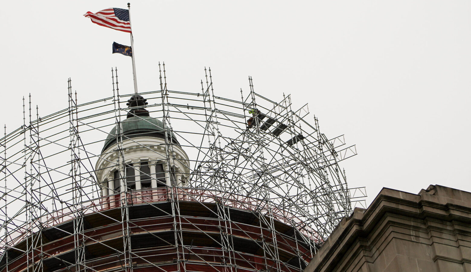 The Statehouse dome is surrounded by scaffolding.