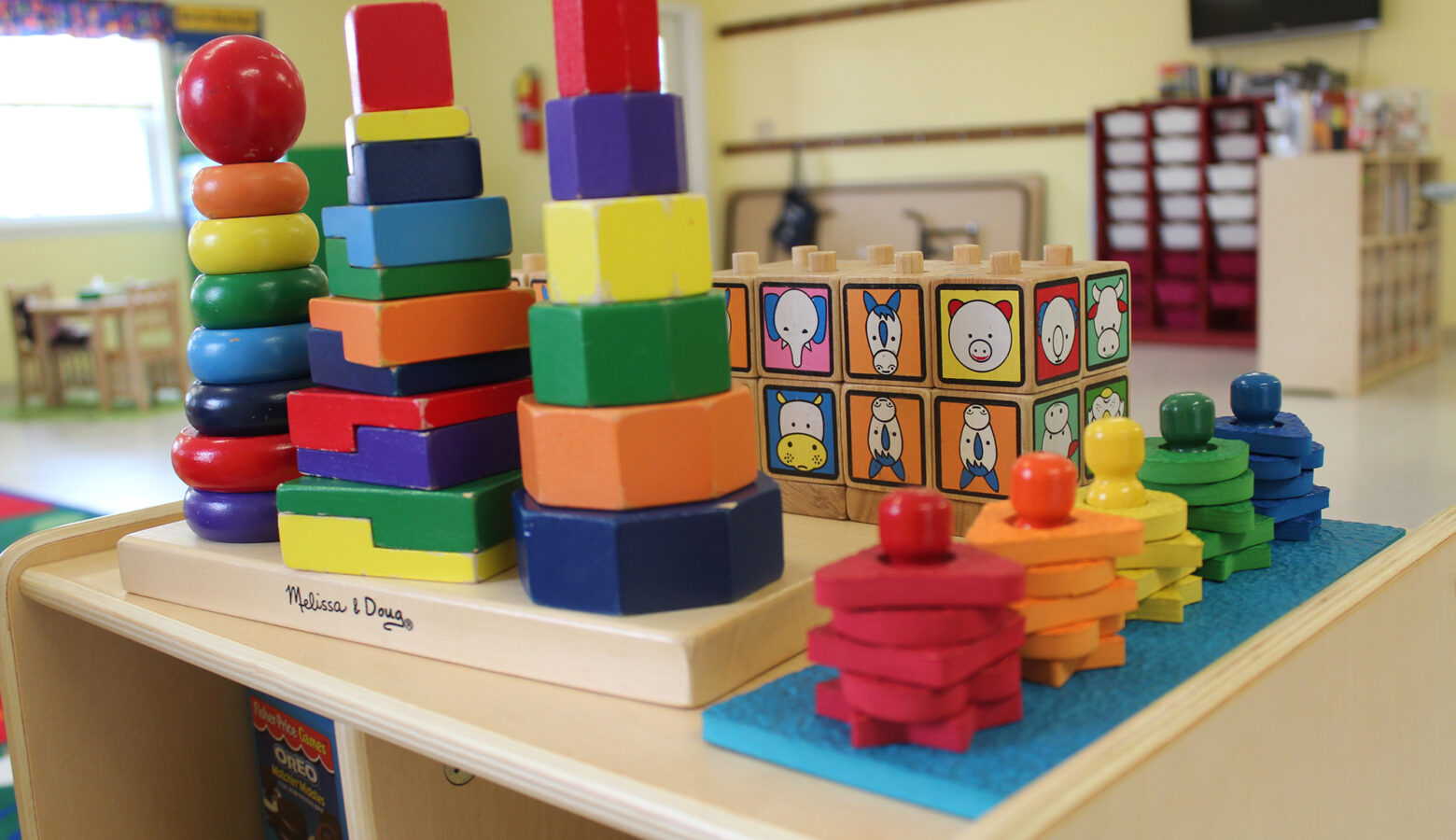 Colorful, stacking block toys in an early childhood education classroom.