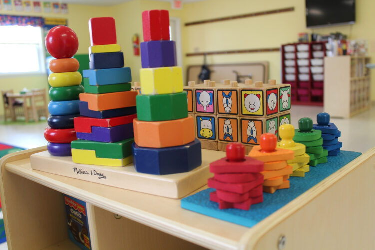 Colorful, stacking block toys in an early childhood education classroom.