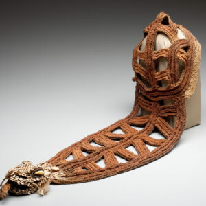 Woven Iatmul bridal headpiece from Papua New Guinea, made of plant fibers and shells, featuring a crocodile-shaped design and open triangular patterns.