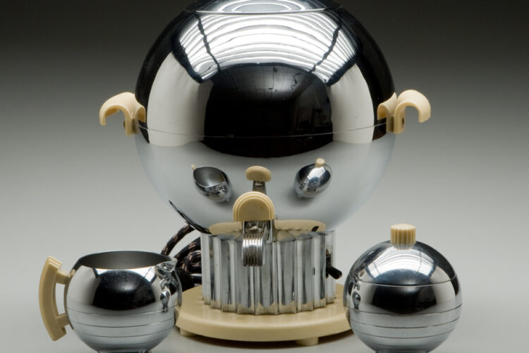 Chrome-plated “Coronet” Coffee Urn by Walter von Nessen with a spherical design, beige Bakelite handles and base, reflecting early 20th-century futurist aesthetics.