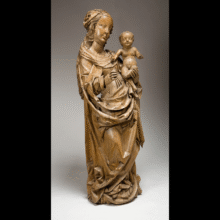 Wooden sculpture of the Virgin Mary holding the infant Christ. The Virgin stands in a contrapposto pose, with flowing, angular drapery and a serene expression. The Christ child is nude, standing upright on her arm and raising one hand in blessing.
