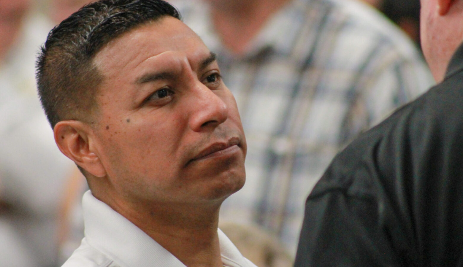 A closeup photo of Indiana Secretary of State Diego Morales speaking to someone in a crowd.