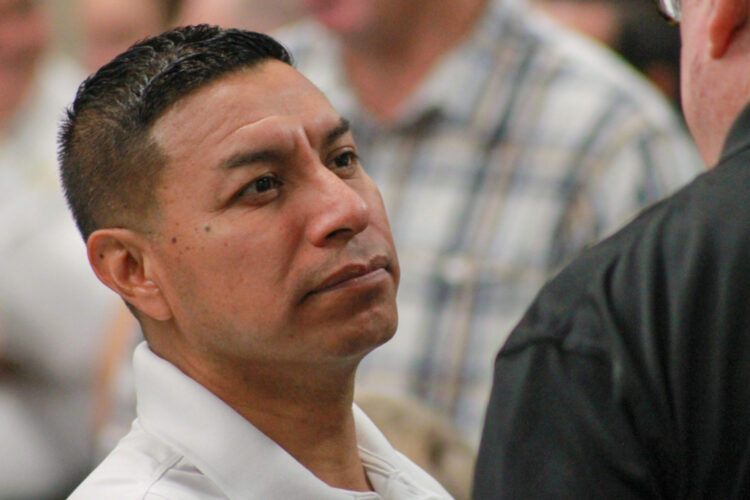 A closeup photo of Indiana Secretary of State Diego Morales speaking to someone in a crowd.