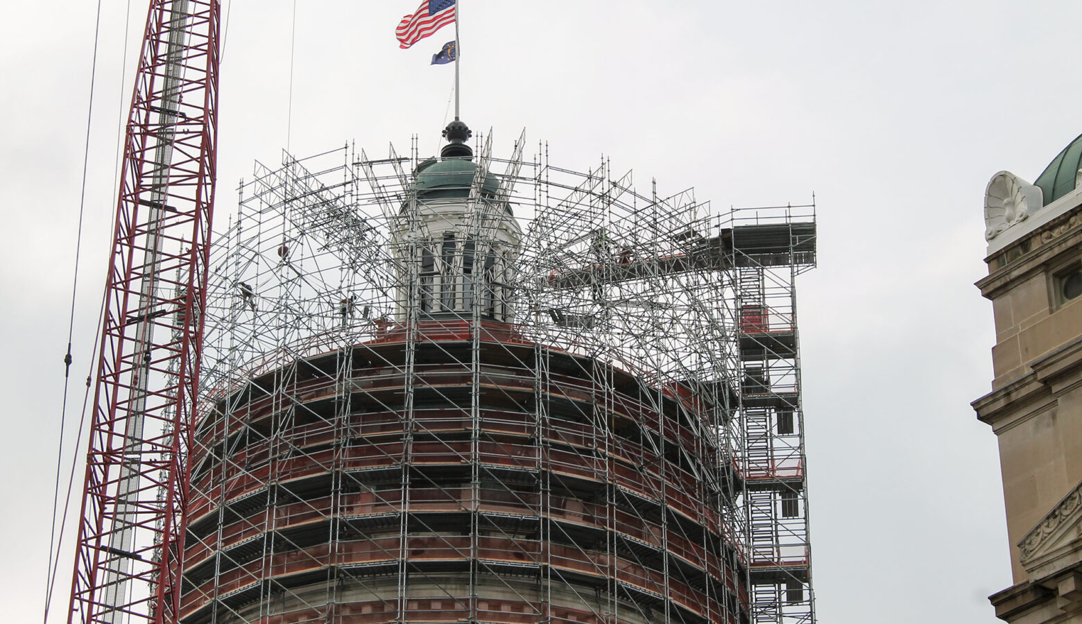 The Statehouse cupola surrounded by scaffolding.