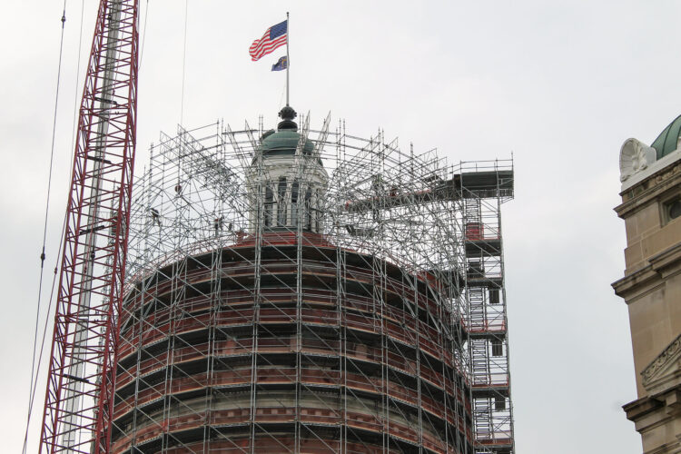 The Statehouse cupola surrounded by scaffolding.