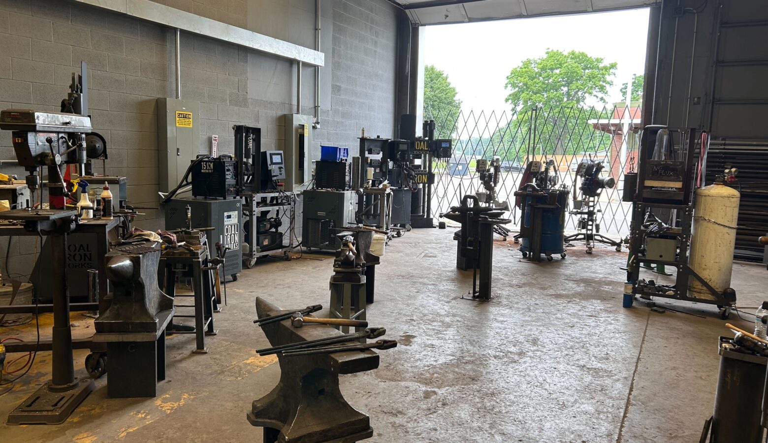 A workshop with several anvils and tools.