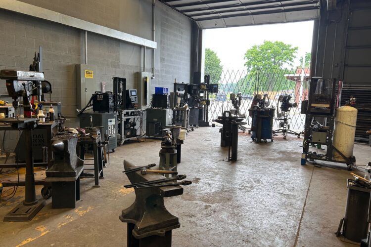 A workshop with several anvils and tools.