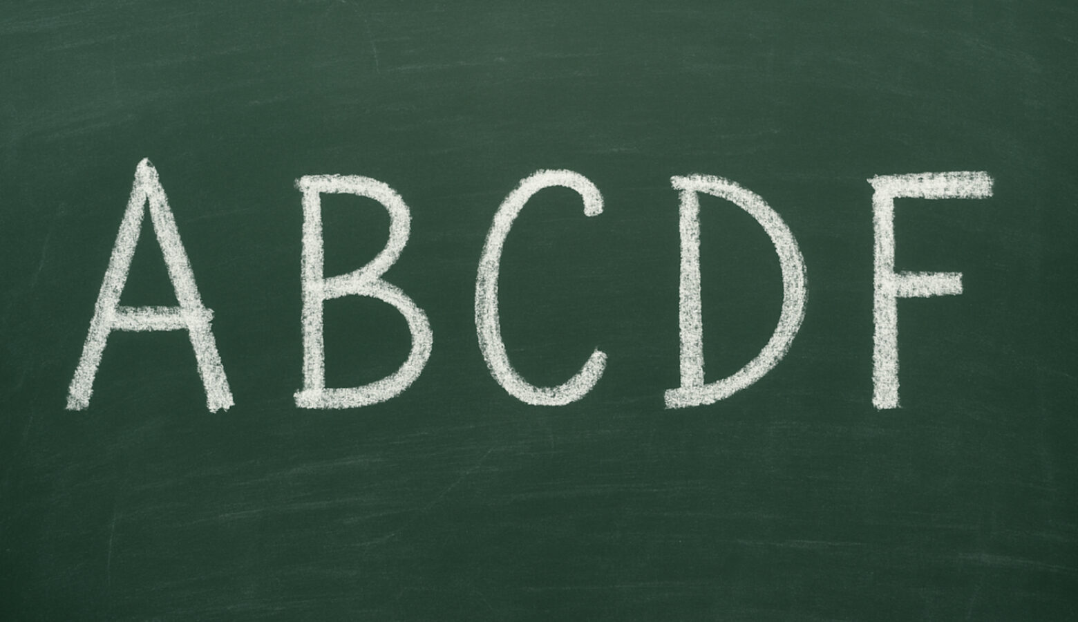 White capital letters A, B, C, D, and F are written on a dark green slate.
