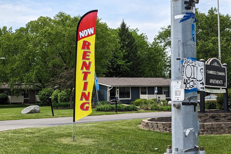 A roadside banner reads "Now Renting."