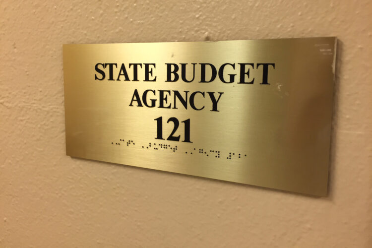 A sign reads "State Budget Agency" along with a room number and Braille.