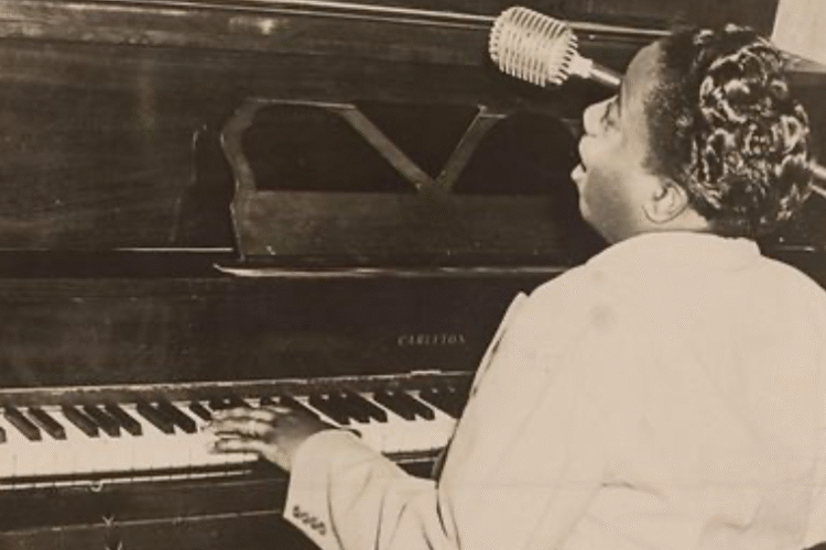 A black and White photograph of Paul Monday at the piano - Smithsonian National Museum of African American History and Culture