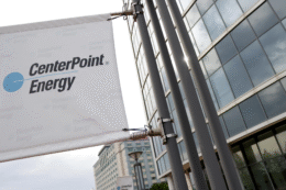 A sign with the CenterPoint logo attached to CenterPoint Energy's office building in Evansville. The logo reads CenterPoint Energy with "energy" underneath the first word. There's a light blue dot on the left side with a blue line running through it and between the two words.