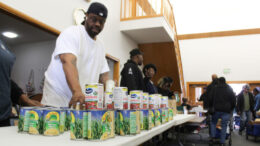 Volunteers stack canned goods at Fountain Square Church of Christ on Indianapolis’ southeast side during a food distribution event on Saturday, Nov. 8, 2025.